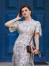 A lady wears a silk floral dress